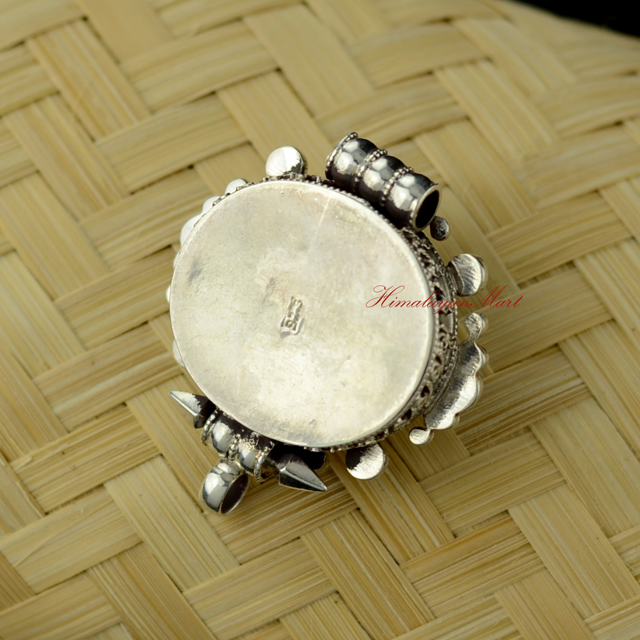 Back view of Himalayan Pendant Jewelry revealing intricate hand-carved silver filigree design.