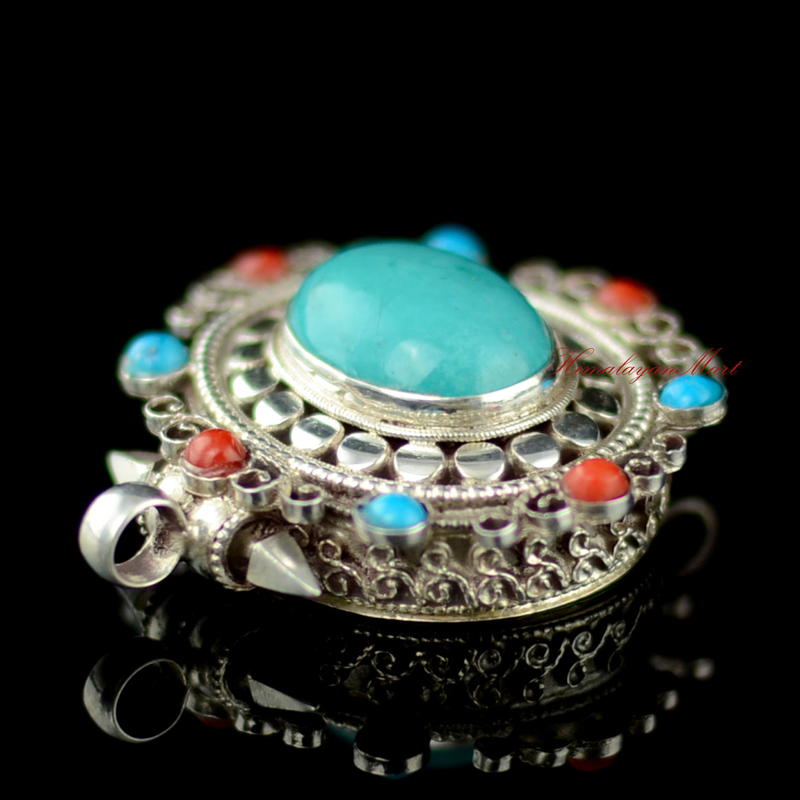 Left-side view of Himalayan Pendant Jewelry displaying handcrafted silver structure and coral accents.
