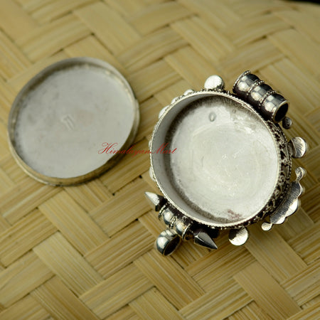 Opened Himalayan Pendant Jewelry showing inner silver craftsmanship and traditional pendant construction.