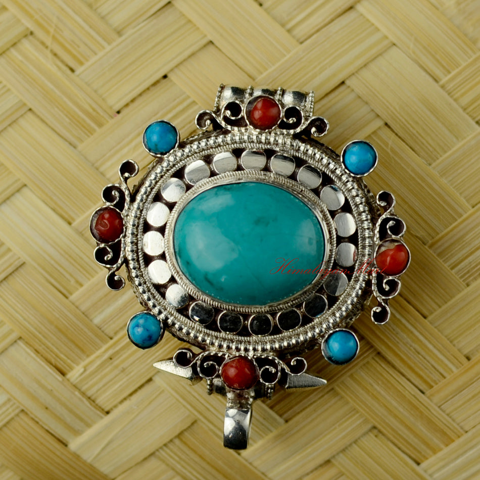 Himalayan Pendant Jewelry handcrafted in solid silver with coral and turquoise gemstones, front view.