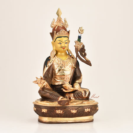 Right side view of the Lotus Born Master Statue showing fine hand-carved detailing, gold-plated lotus hat, vajra, and red polished accents crafted by master artisans in Patan, Nepal