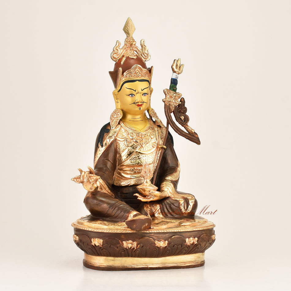 Right side view of the Lotus Born Master Statue showing fine hand-carved detailing, gold-plated lotus hat, vajra, and red polished accents crafted by master artisans in Patan, Nepal