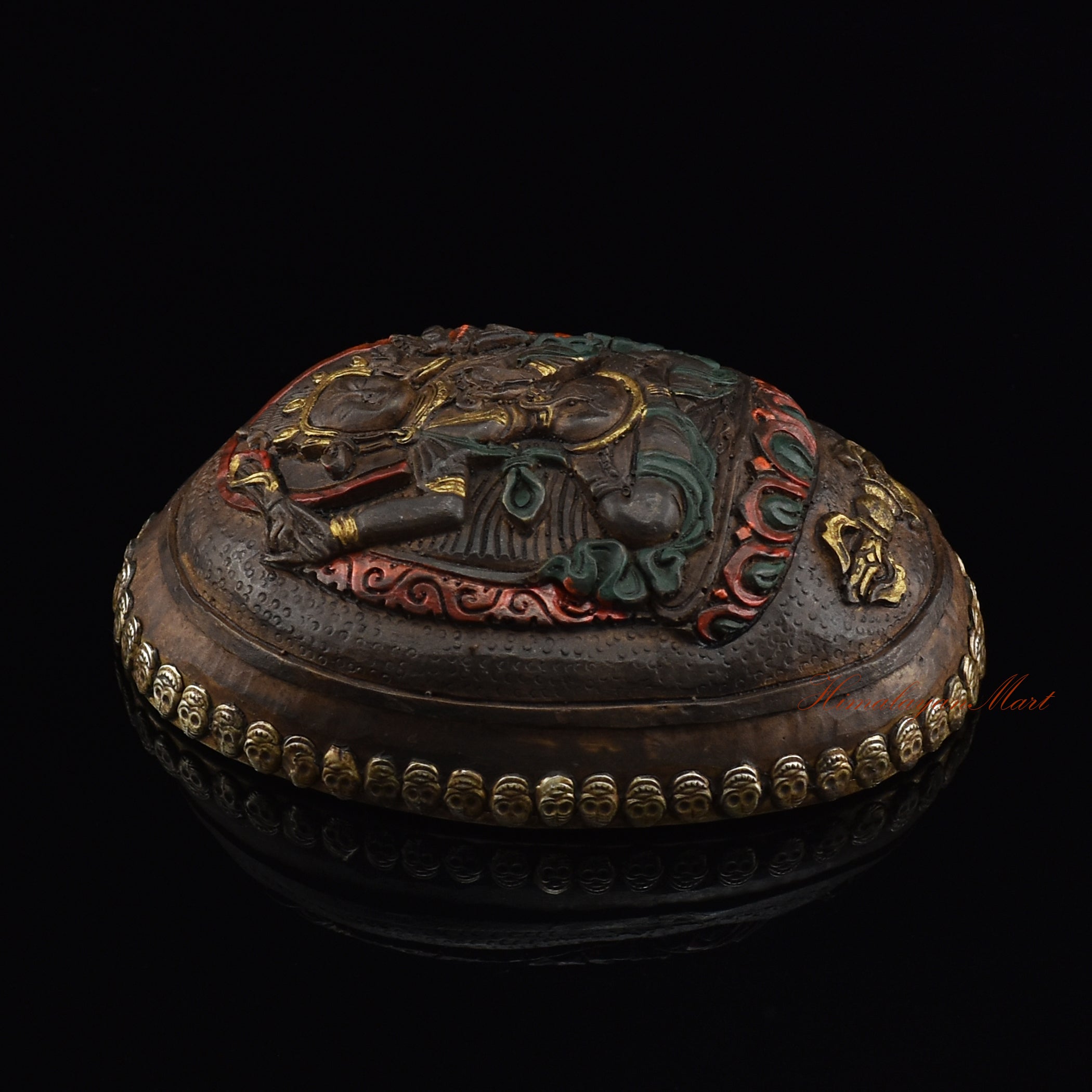 Left side view of the Manjushri Carved Resin Kapala highlighting the silver-plated copper accents