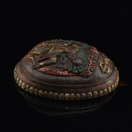Left side view of the Manjushri Carved Resin Kapala highlighting the silver-plated copper accents