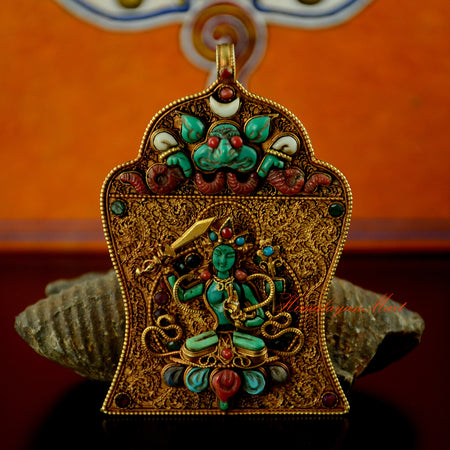 Manjushri Silver Pendant handcrafted in gold-plated silver, featuring a turquoise Manjushri figure with coral, lapis lazuli, emerald, ruby, and shell gemstone inlay.