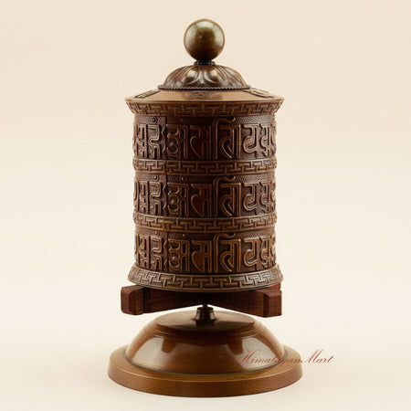 Meditation Tabletop Prayer Wheel handcrafted in copper, brass, and white metal on a wooden base, a sacred Buddhist mantra wheel for daily prayer and meditation.