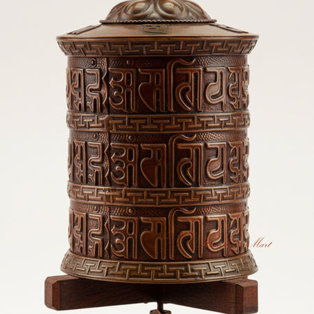 Close-up detail of the Meditation Tabletop Prayer Wheel showing engraved Buddhist mantras and decorative metalwork crafted in copper, brass, and white metal.
