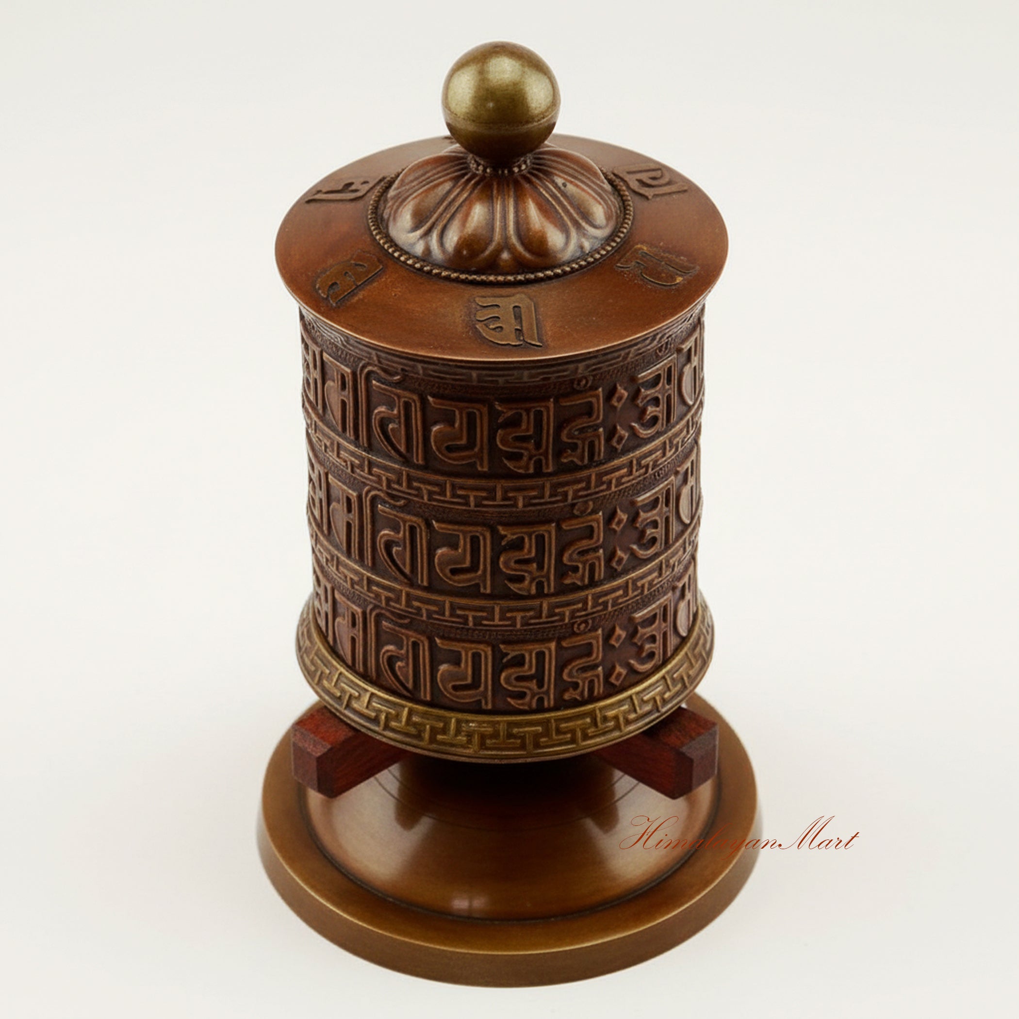 Top view of the Meditation Tabletop Prayer Wheel highlighting the engraved mantra cylinder and traditional handcrafted metal detailing.