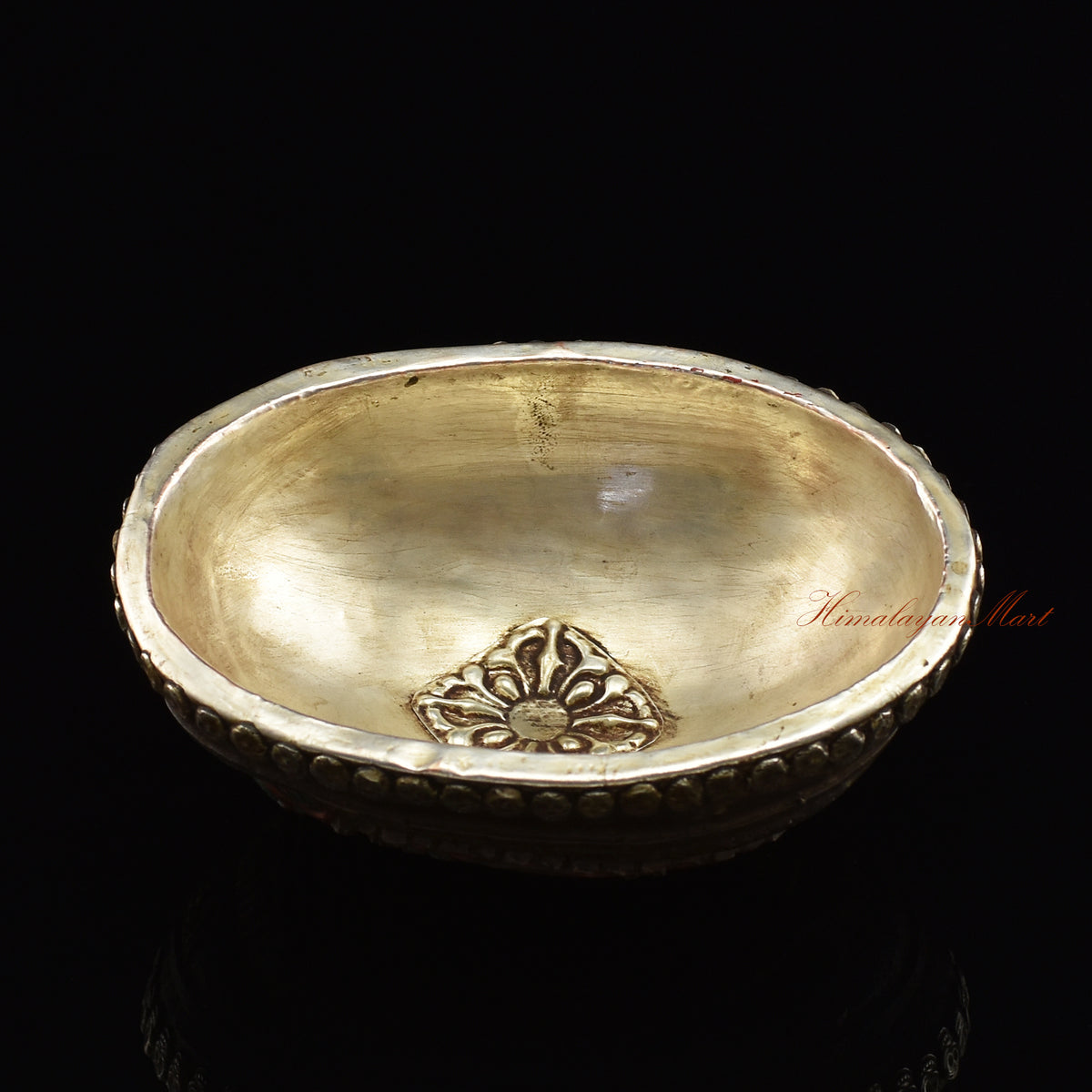 Angled top view of the Namtose Vaisravana Resin Kapala capturing the full carved figure and metal skull detailing