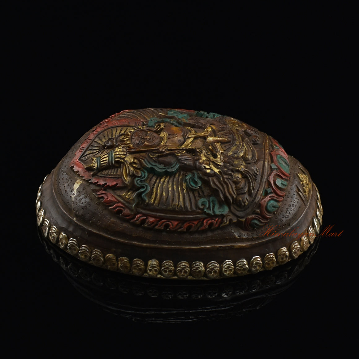 Left side view of the Namtose Vaisravana Resin Kapala highlighting the silver-plated copper accents