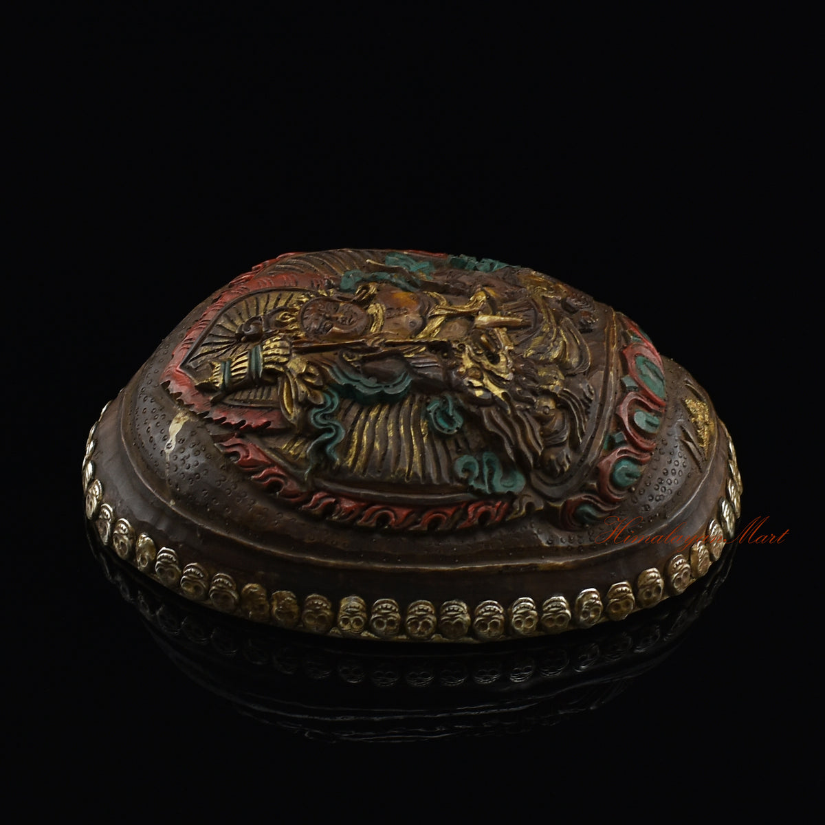 Left side view of the Namtose Vaisravana Resin Kapala highlighting the silver-plated copper accents