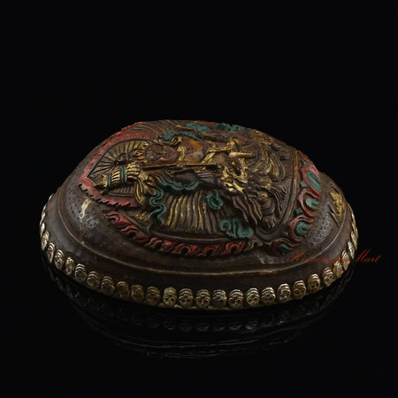 Left side view of the Namtose Vaisravana Resin Kapala highlighting the silver-plated copper accents