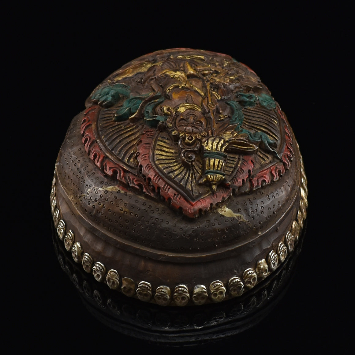 Top view of the Namtose Vaisravana Resin Kapala displaying the carved Vaisravana figure and skull-border design
