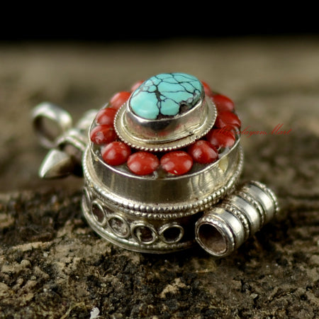 Angled view of Nepalese Handcrafted Pendant highlighting hand-carved silver and gemstone craftsmanship.
