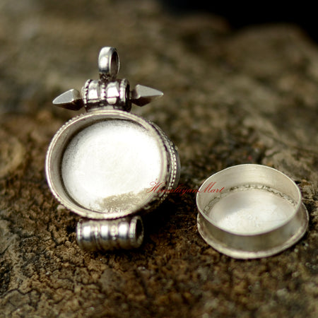 Opened view of Nepalese Handcrafted Pendant revealing hand-carved silver interior with turquoise and coral settings.