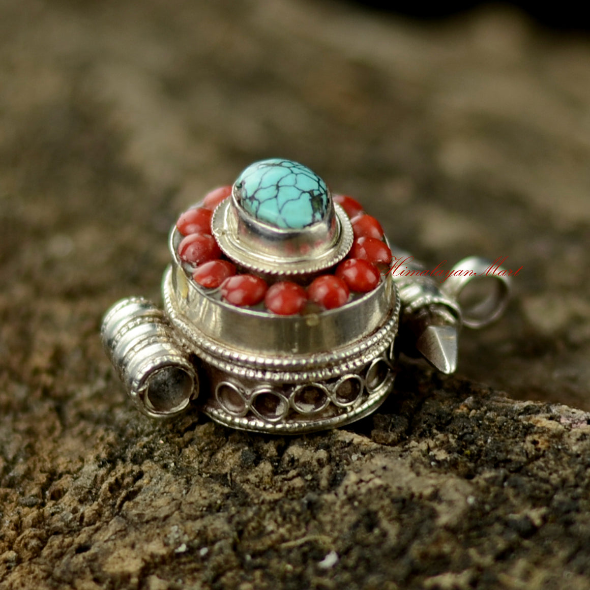 Right view of Nepalese Handcrafted Pendant showing detailed silver carving and turquoise coral setting.