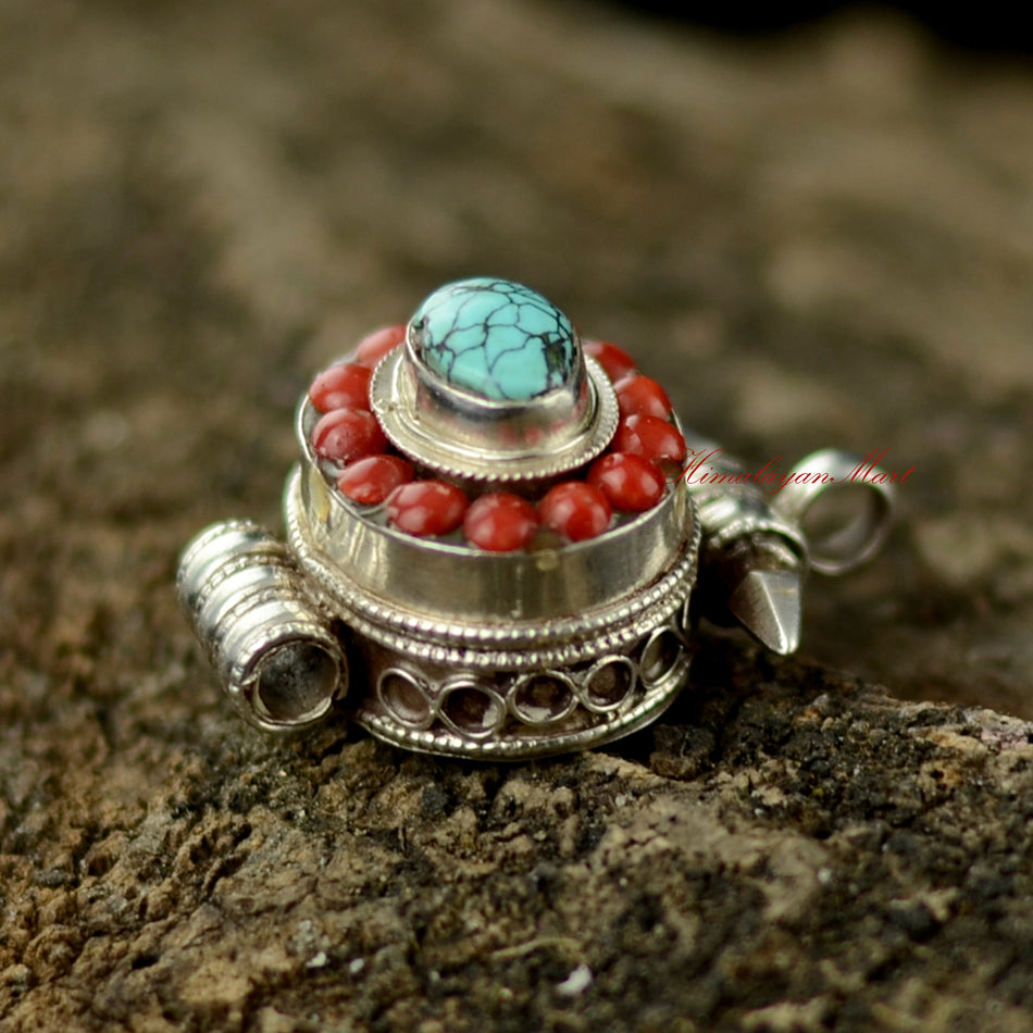 Right view of Nepalese Handcrafted Pendant showing detailed silver carving and turquoise coral setting.