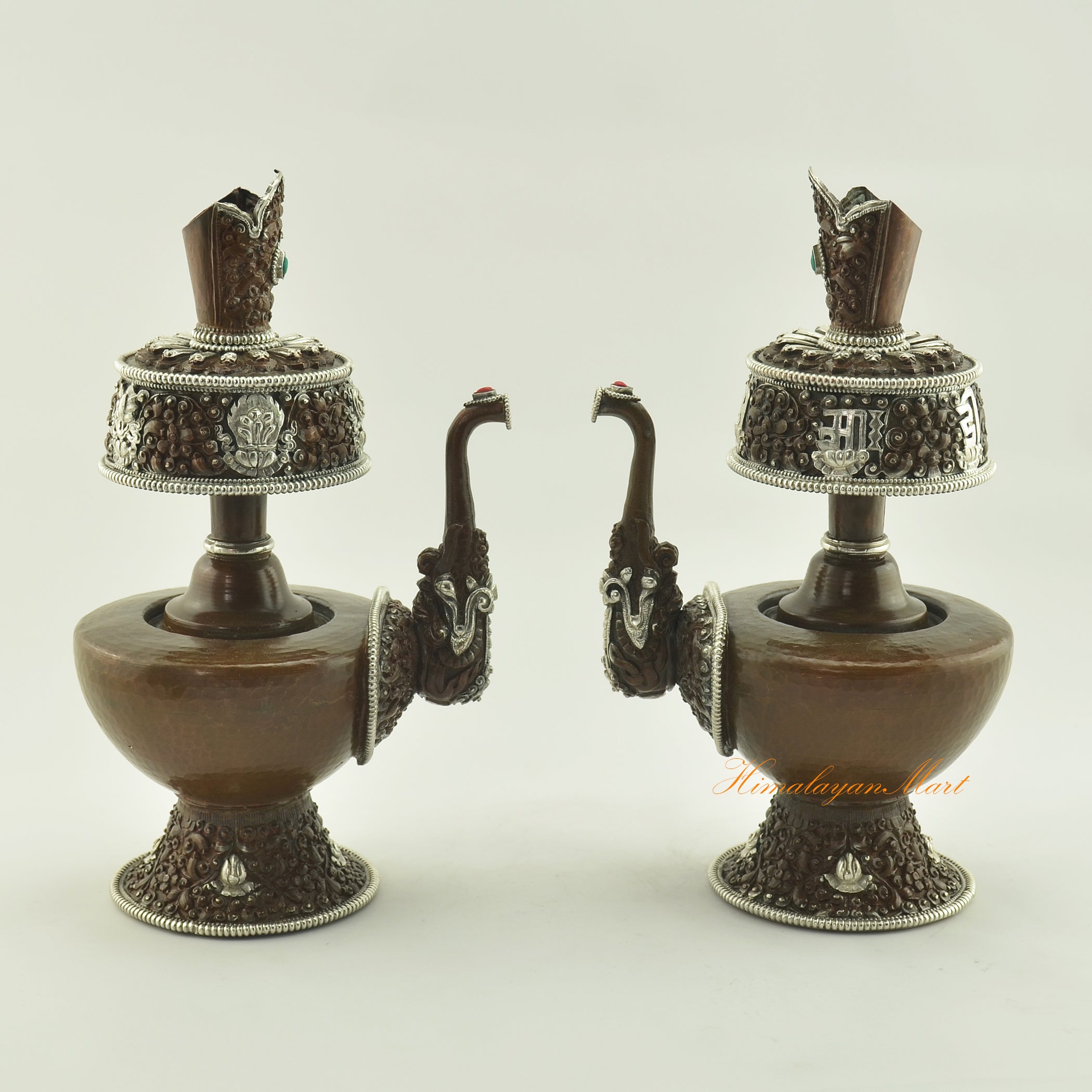 Two Oxidized Copper Bhumba Set vases displayed together, handcrafted with coral and turquoise inlay for Tibetan Buddhist rituals.