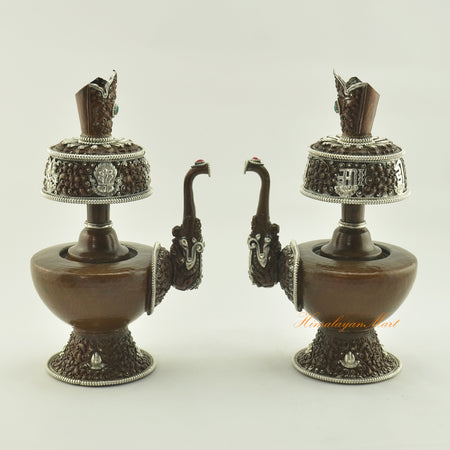 Two Oxidized Copper Bhumba Set vases displayed together, handcrafted with coral and turquoise inlay for Tibetan Buddhist rituals.