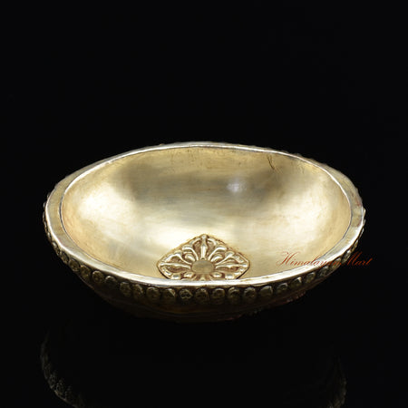 Angled top view of the Panjarnata Mahakala Resin Kapala capturing the full carved figure and metal skull detailing