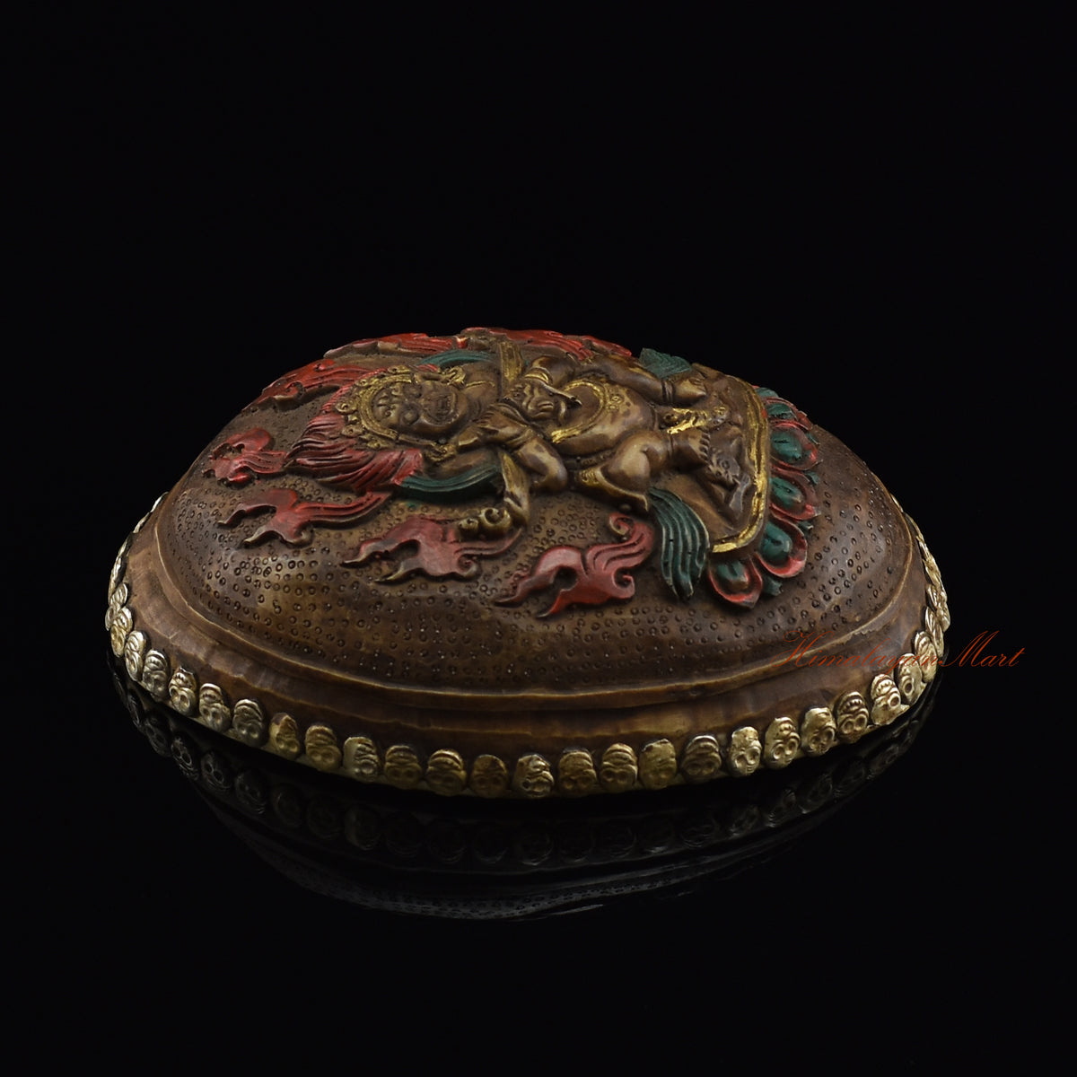Left side view of the Panjarnata Mahakala Resin Kapala highlighting the silver-plated copper accents
