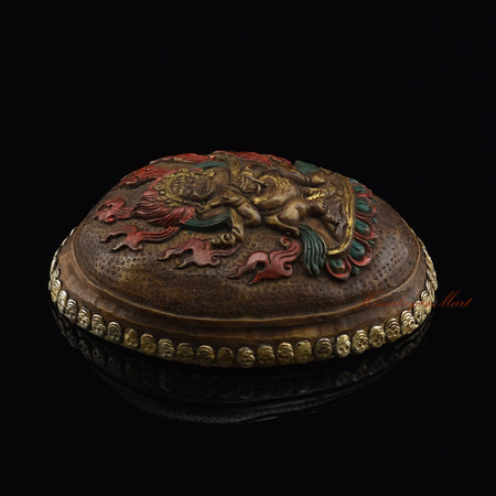 Left side view of the Panjarnata Mahakala Resin Kapala highlighting the silver-plated copper accents