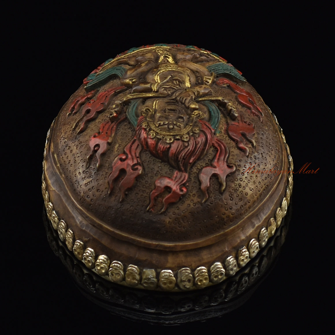 Top view of the Panjarnata Mahakala Resin Kapala displaying the carved Mahakala figure and skull-border design