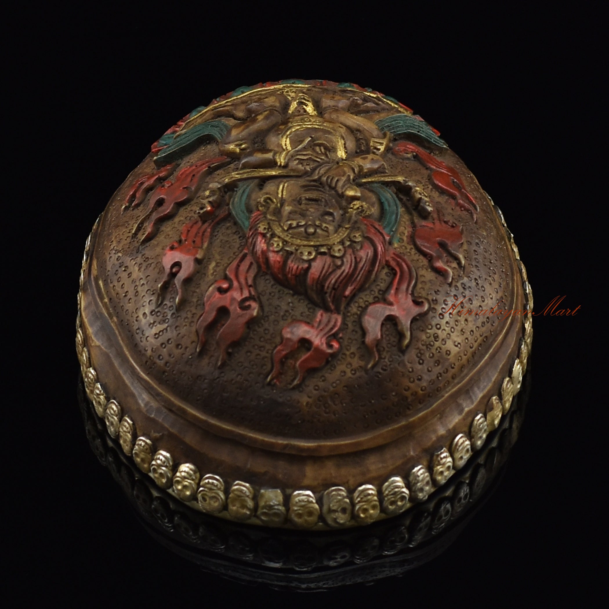 Top view of the Panjarnata Mahakala Resin Kapala displaying the carved Mahakala figure and skull-border design