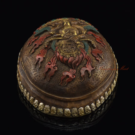 Top view of the Panjarnata Mahakala Resin Kapala displaying the carved Mahakala figure and skull-border design