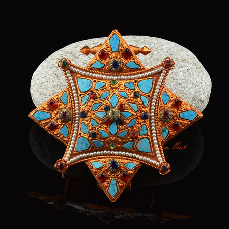 Front view of handcrafted Religious Ghau Pendant in brass with gold and silver plating and gemstones.