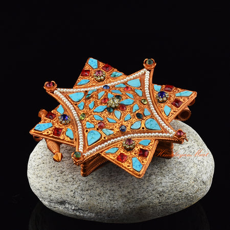 Left angle of Religious Ghau Pendant highlighting gold and silver accents and hand-decorated gemstones.