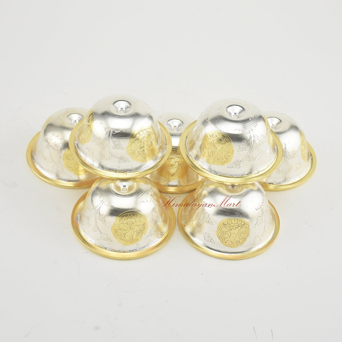 Angled upper view of Seven Tibetan Offering Bowls revealing intricate sacred patterns.