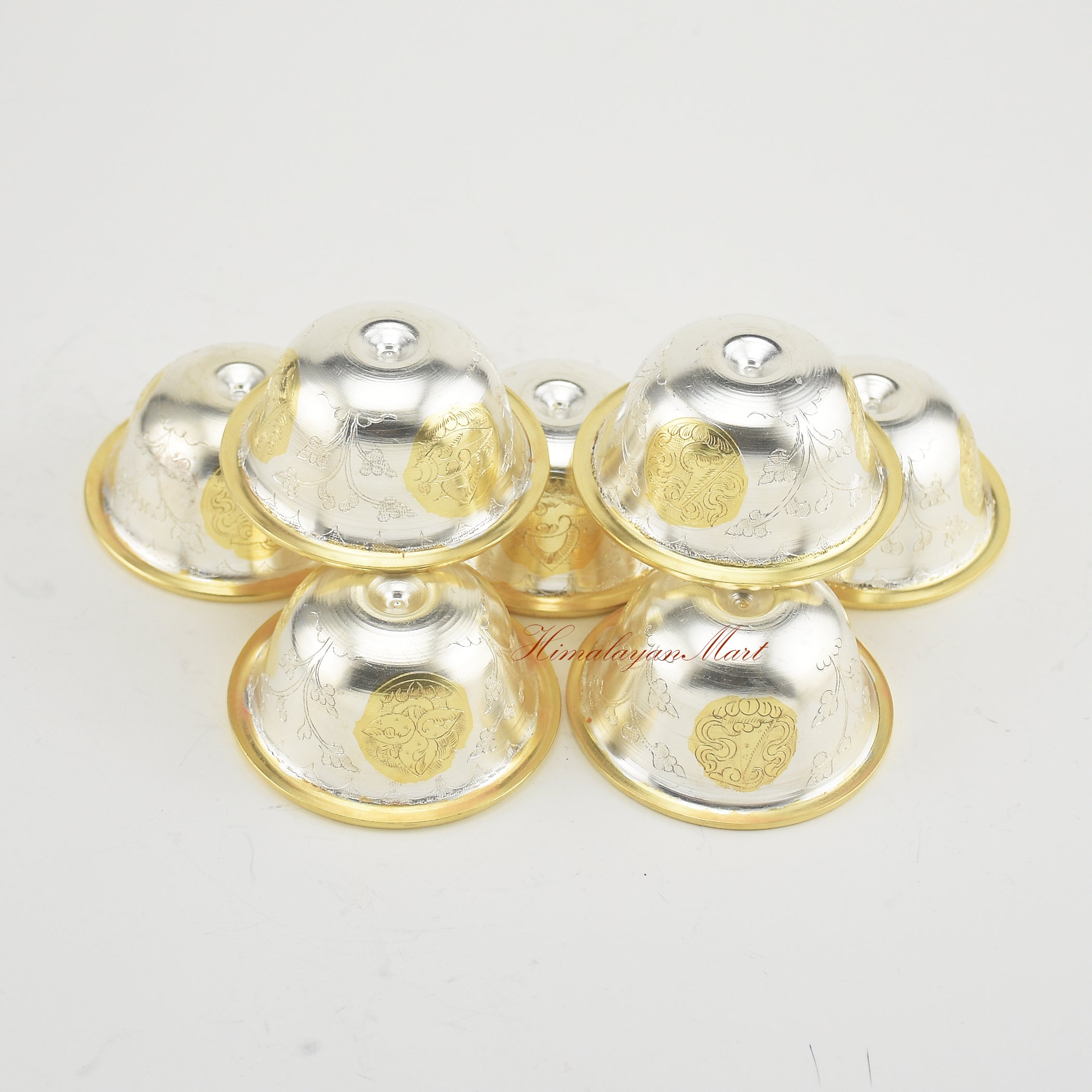 Angled upper view of Seven Tibetan Offering Bowls revealing intricate sacred patterns.