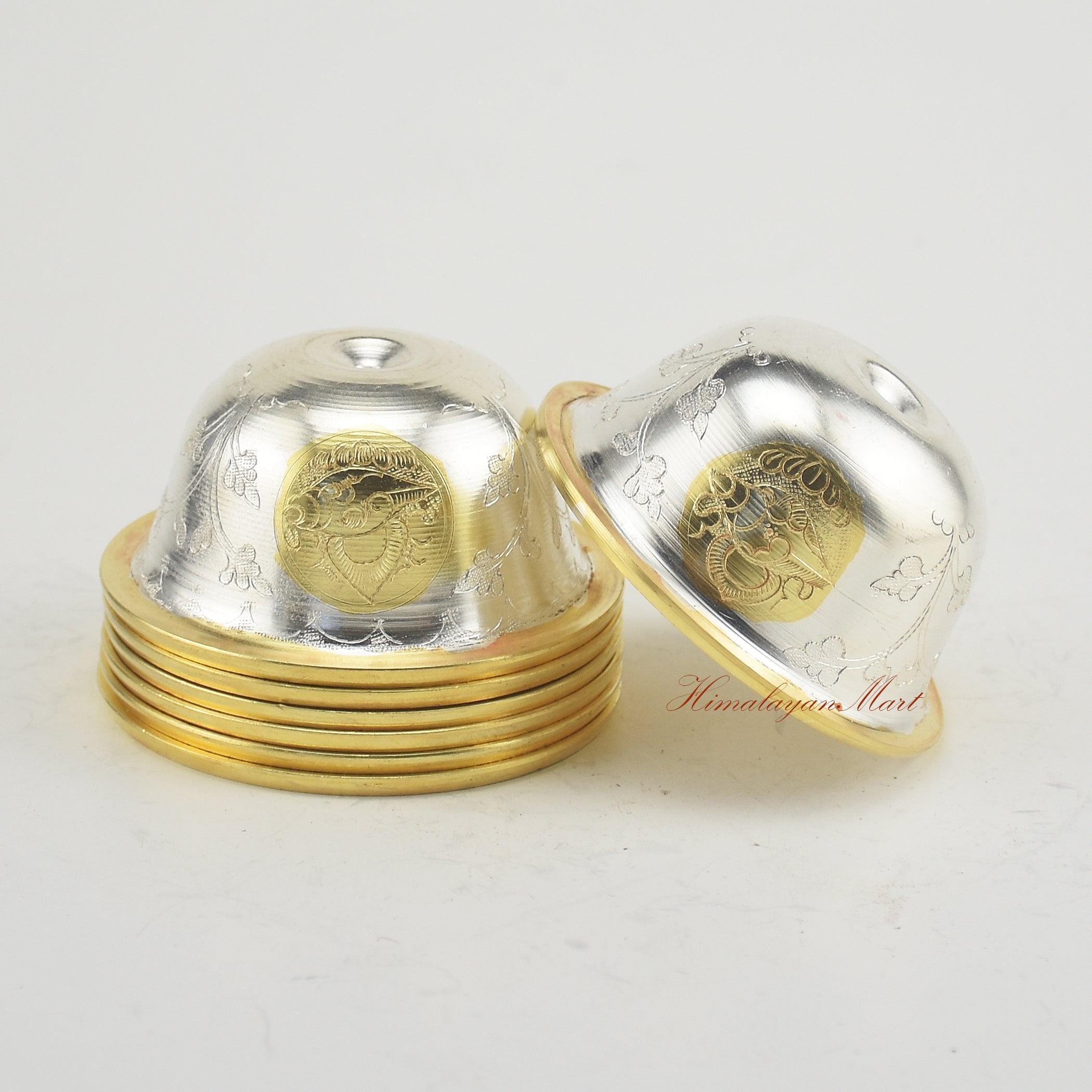 Close side perspective of Seven Tibetan Offering Bowls emphasizing plated details and hand-carved motifs.