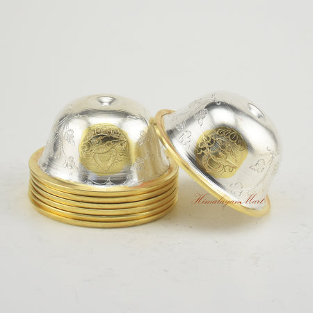 Close side perspective of Seven Tibetan Offering Bowls emphasizing plated details and hand-carved motifs.