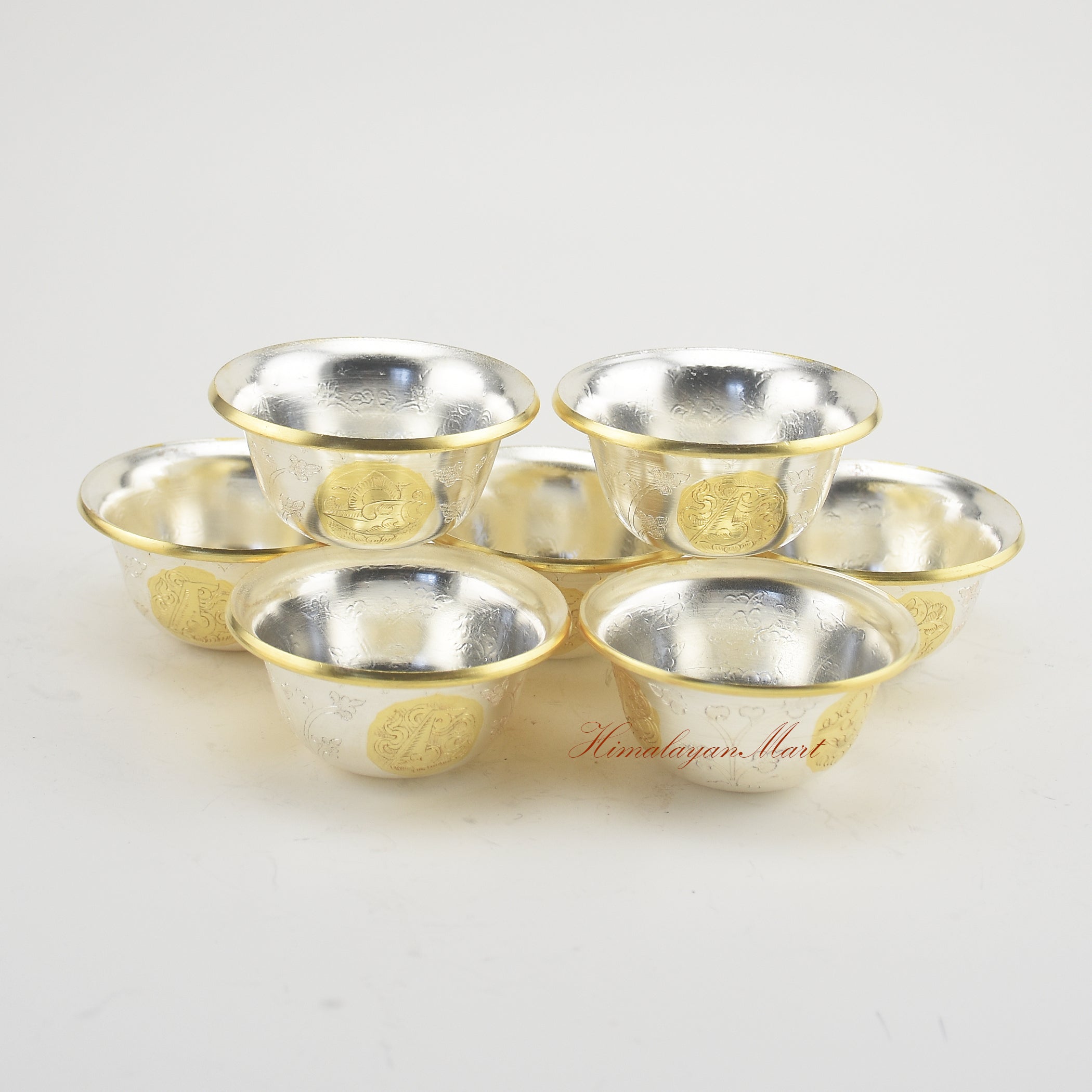 Complete set of Seven Tibetan Offering Bowls displayed on a Buddhist shrine for ritual practice.