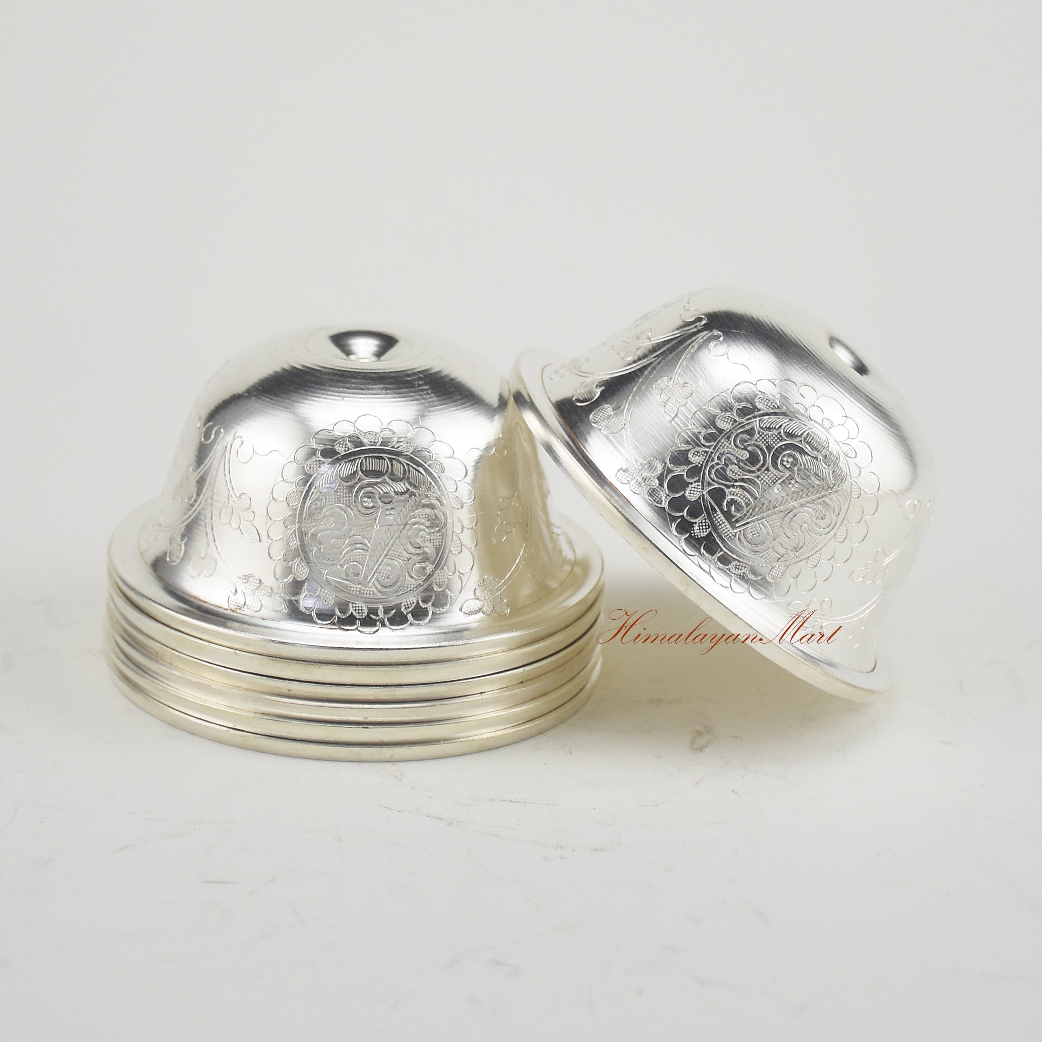 Side view of Silver-Plated Water Offering Bowls with traditional Buddhist carving details