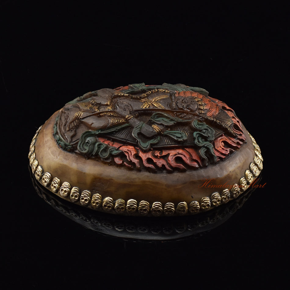 Right side view of the Simhamukha Dakini Resin Kapala showing silver-plated copper detailing