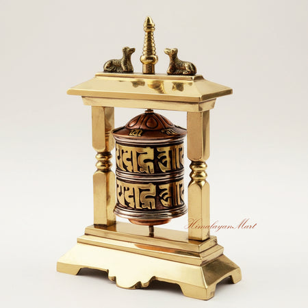 Detailed left-angle view of a Table Top Prayer Wheel with brass and white metal craftsmanship, featuring deer motifs and intricate mantra carvings for spiritual practice.