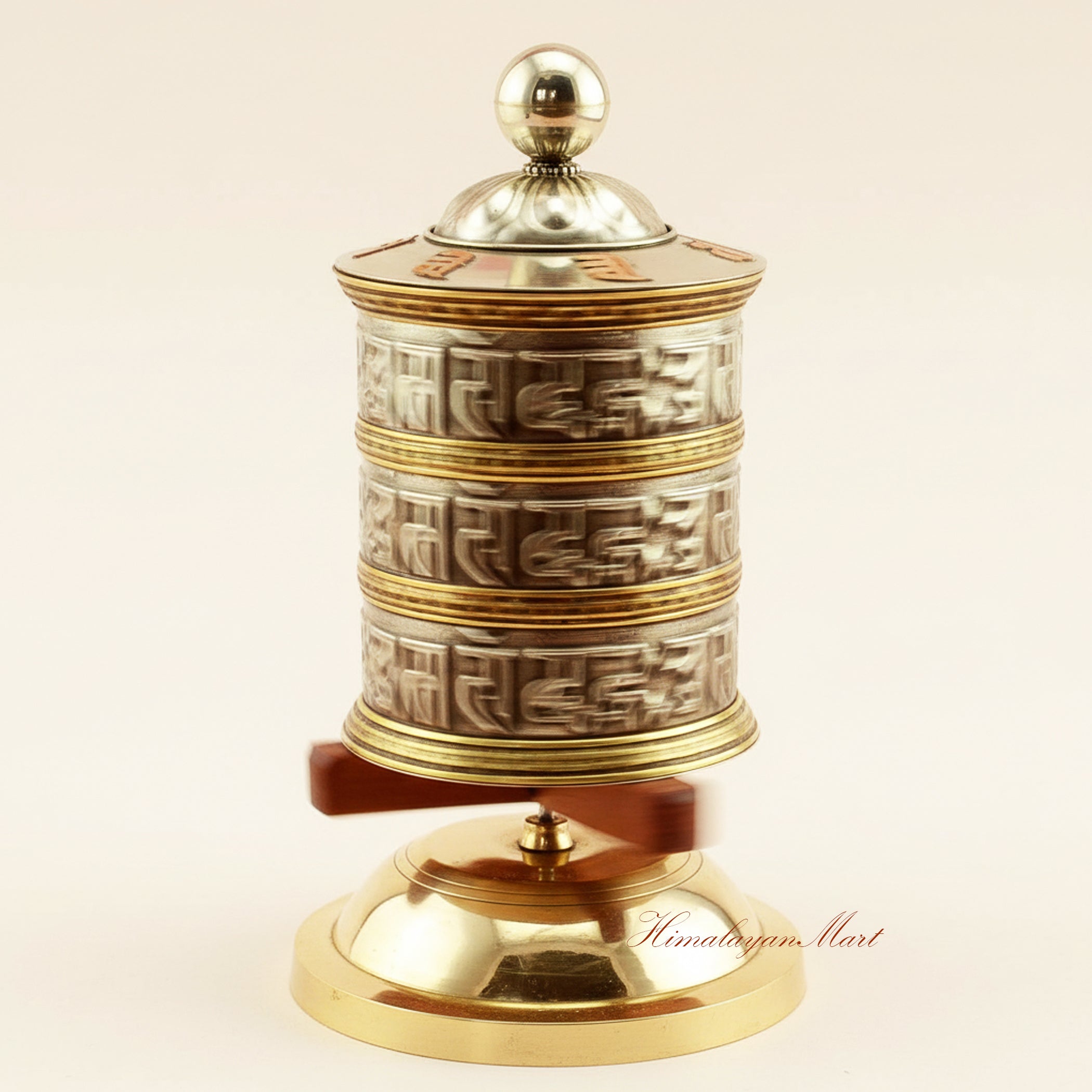 Tabletop Mani Prayer Wheel in motion on a wooden stand, illustrating traditional Tibetan Buddhist ritual use during meditation.
