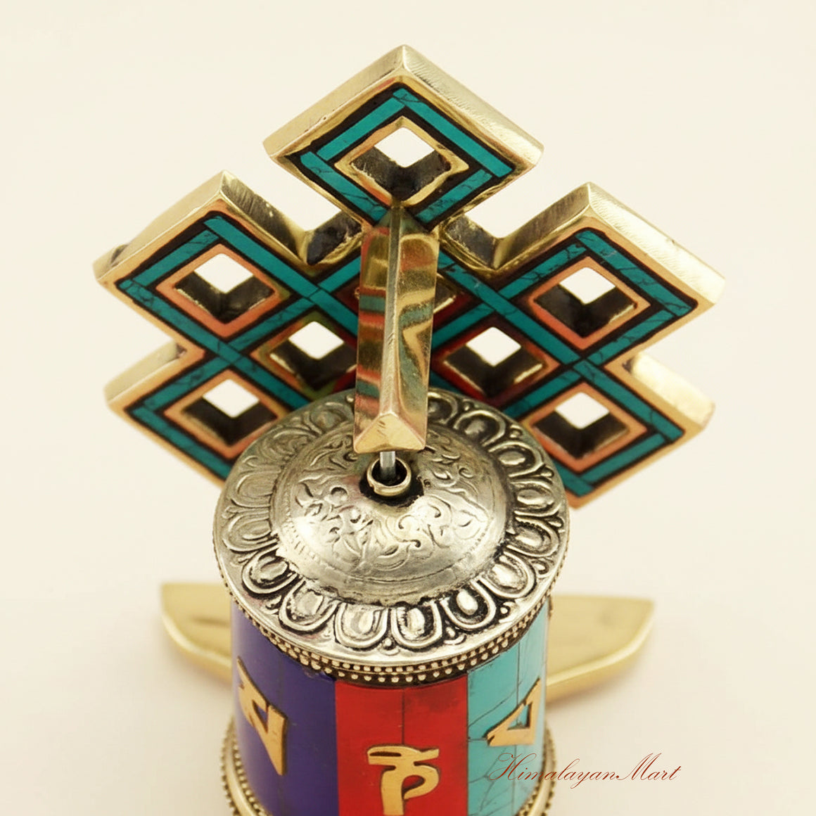 Close-up detail of the mantra cylinder and stone inlay on a Tabletop Ritual Prayer Wheel, showcasing fine engraving.