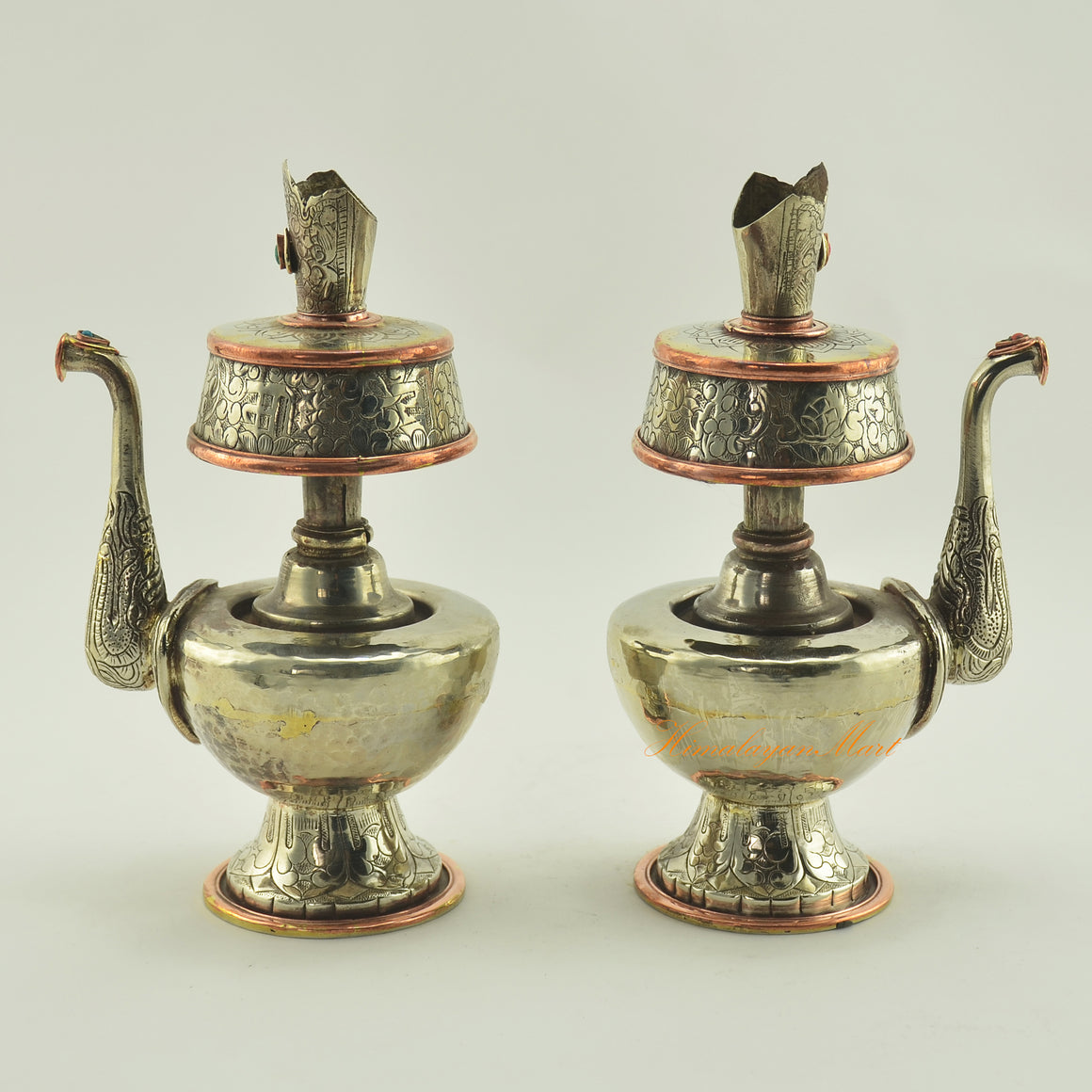Left and right view of Tibetan Buddhist Ritual Bhumba offering vase set crafted in white metal with copper ring accents
