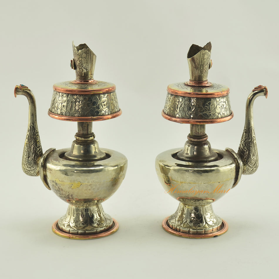 Left and right view of Tibetan Buddhist Ritual Bhumba offering vase set crafted in white metal with copper ring accents
