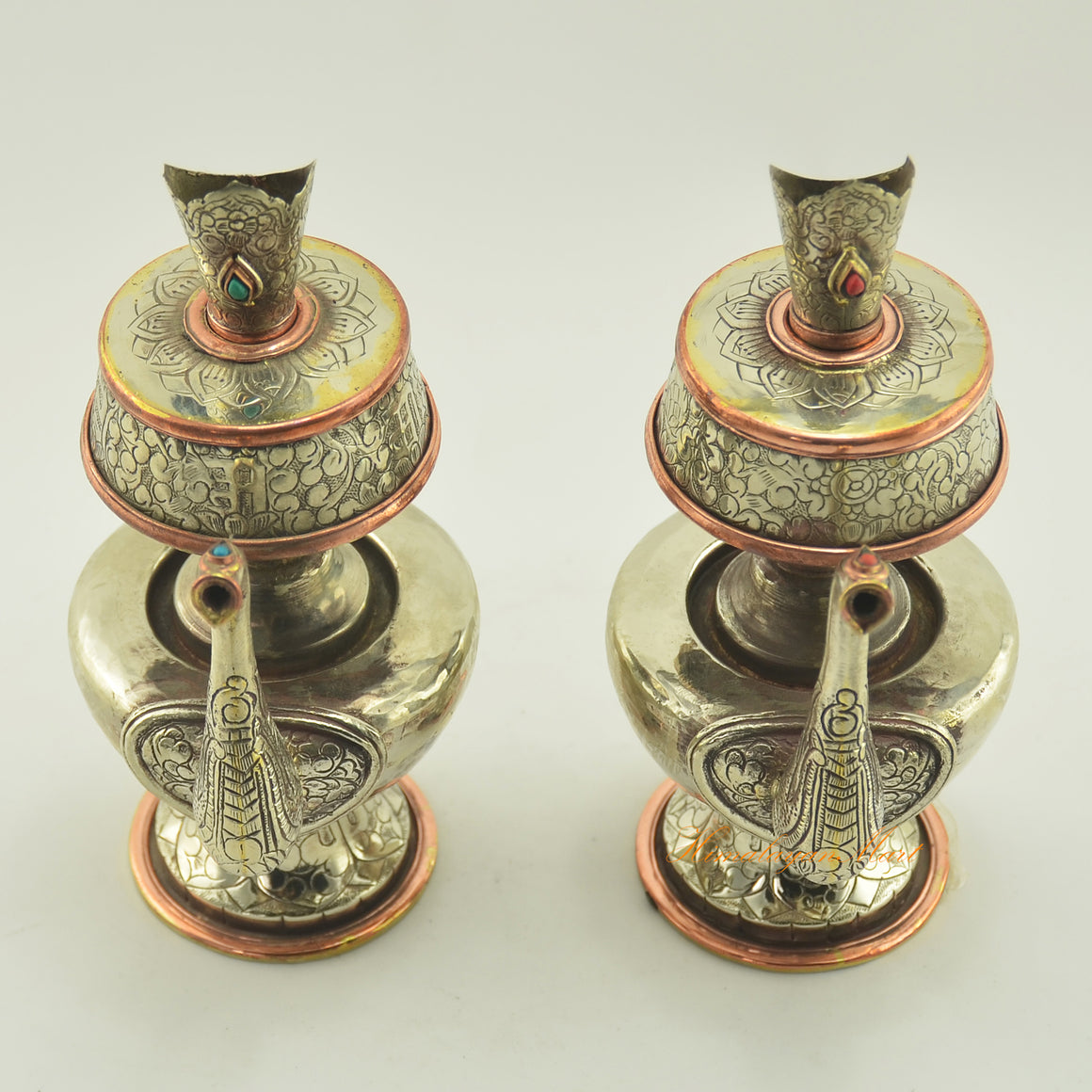 Upper view of Tibetan Buddhist Ritual Bhumba offering vase set highlighting hand carvings and inlaid coral and turquoise