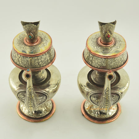 Upper view of Tibetan Buddhist Ritual Bhumba offering vase set highlighting hand carvings and inlaid coral and turquoise