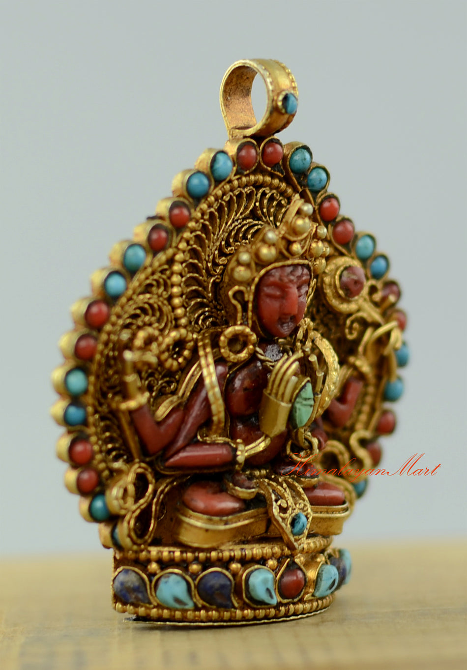 Right-side view of the Tibetan Chenrezig Locket highlighting gold-plated accents and precise gemstone settings.