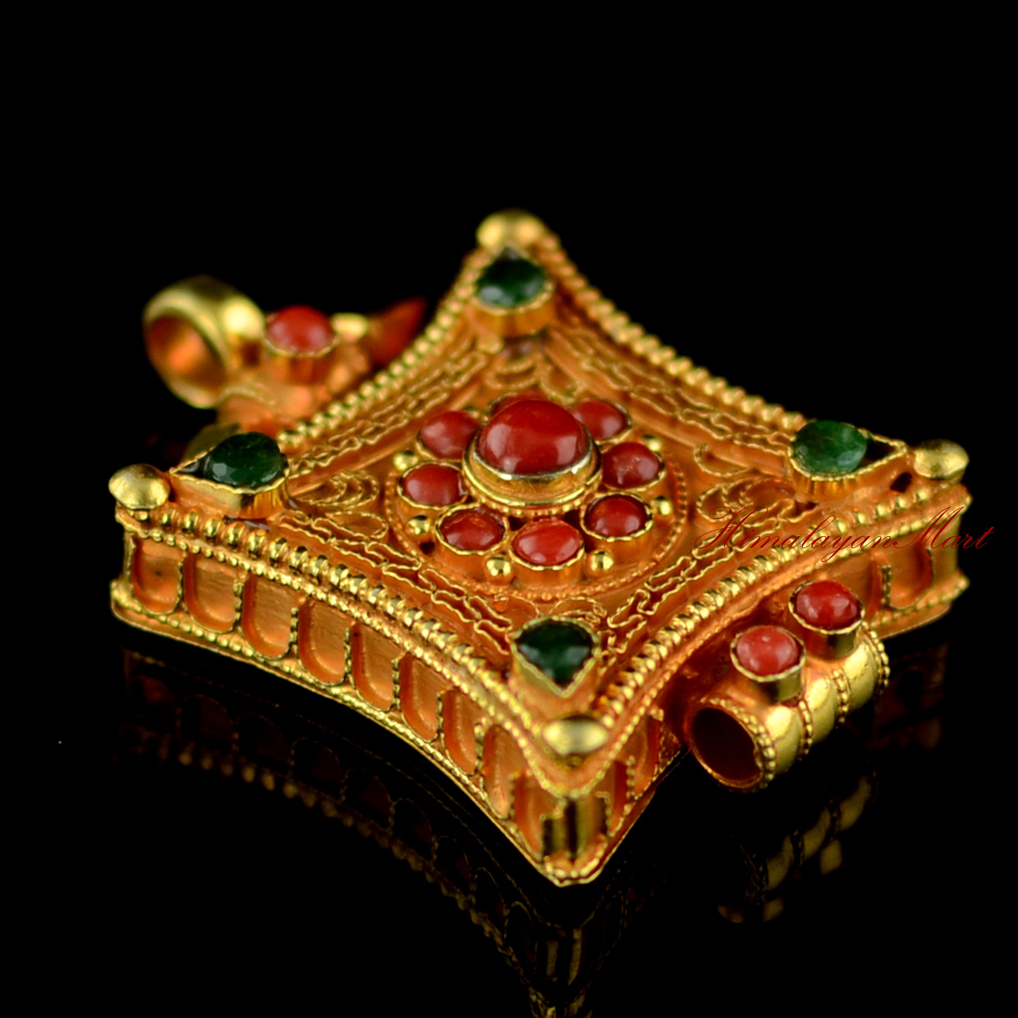 Left-side angle of Tibetan gemstone pendant highlighting detailed silver filigree and gemstone settings.