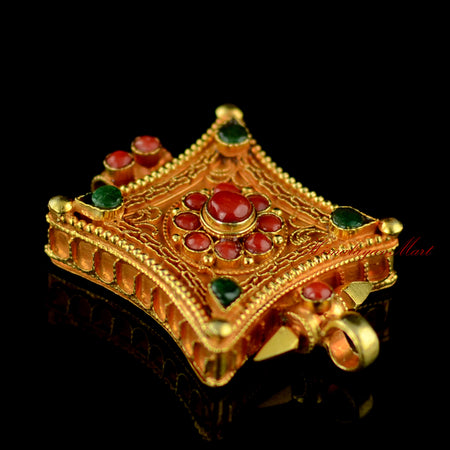 Right-side view of Tibetan gemstone pendant showcasing silver craftsmanship and coral and emerald inlays.