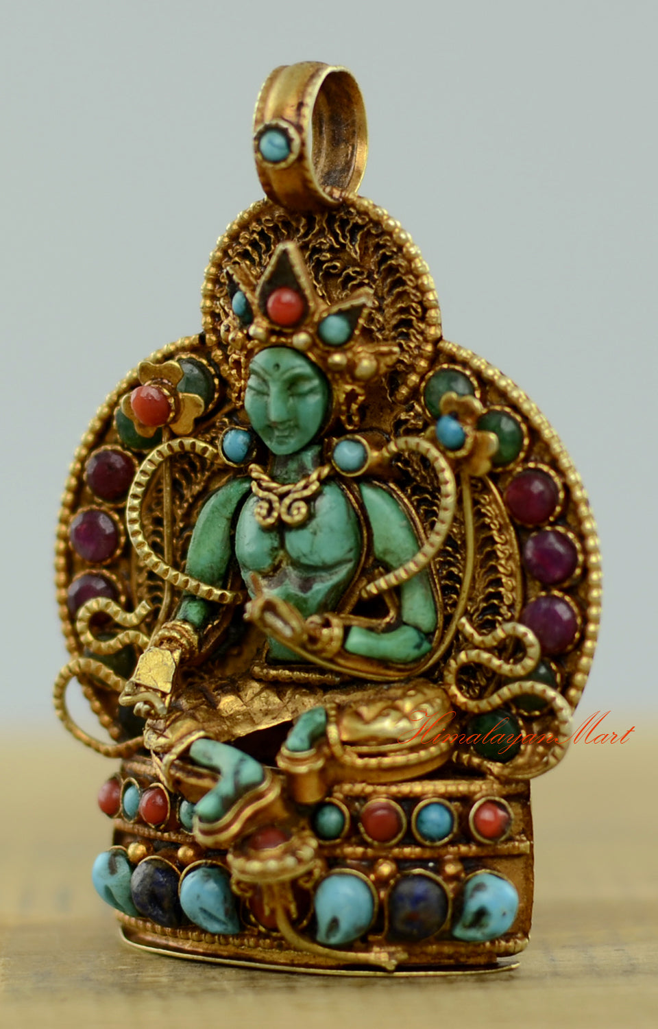 Left-side view of the Tibetan Green Tara Locket showing precise stone settings and intricate filigree.