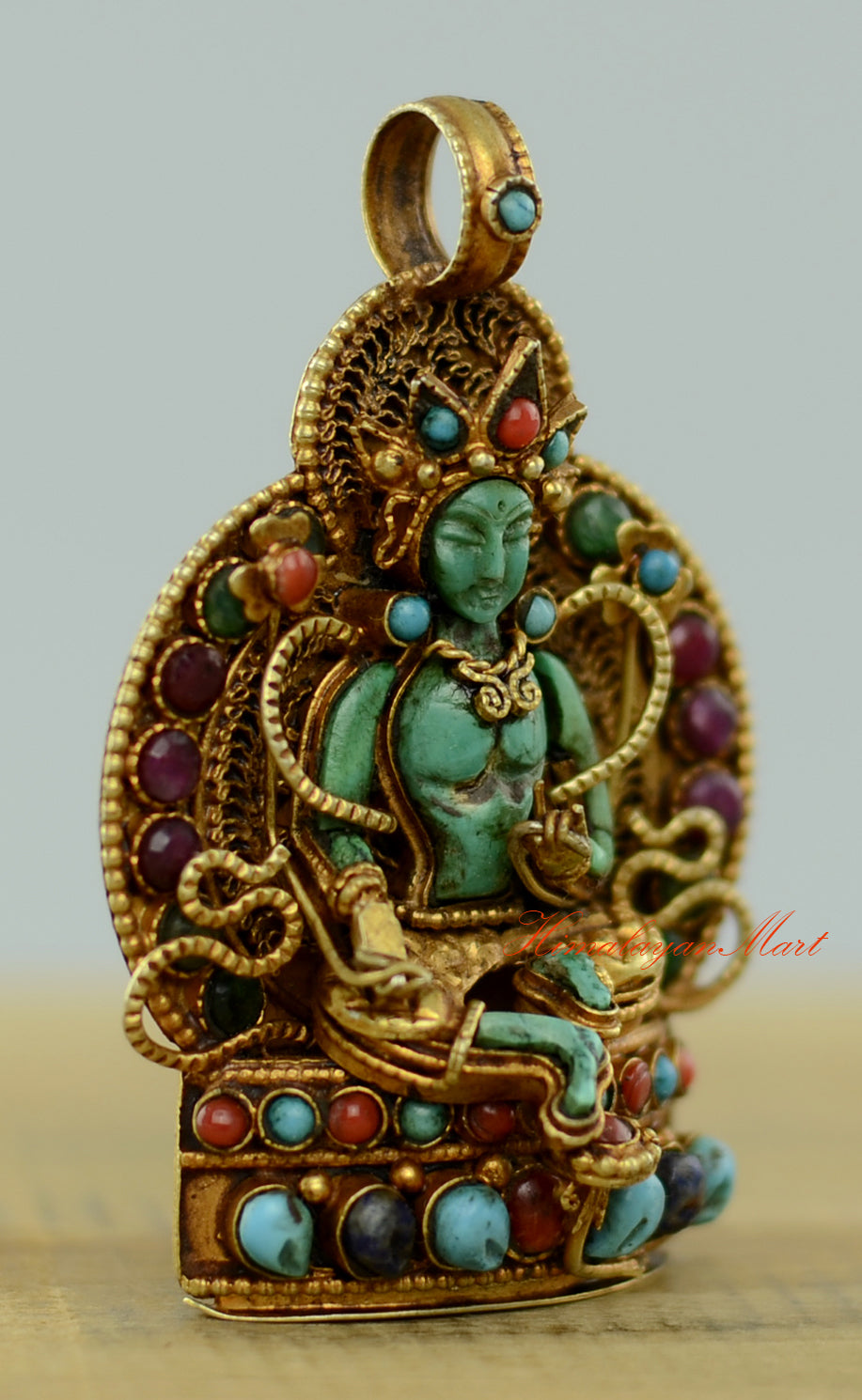 Right-side view of the Tibetan Green Tara Locket highlighting gold-plated accents and gemstone inlay.